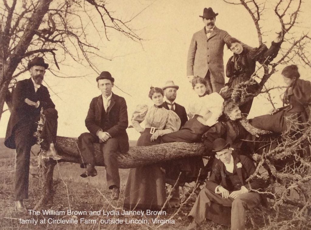 old photograph of family on fallen tree