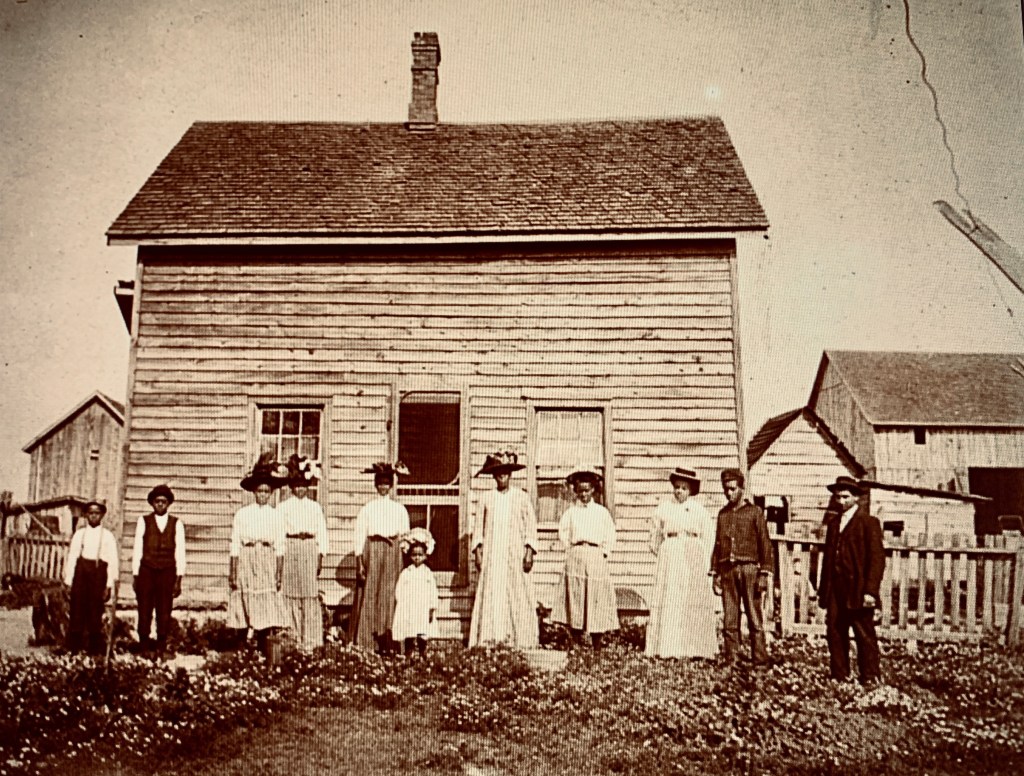 black canadians outside farmhouse