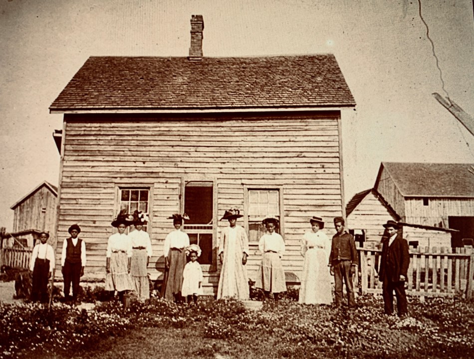 black canadians outside farmhouse