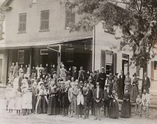 19th century quakers standing outside meetinghouse
